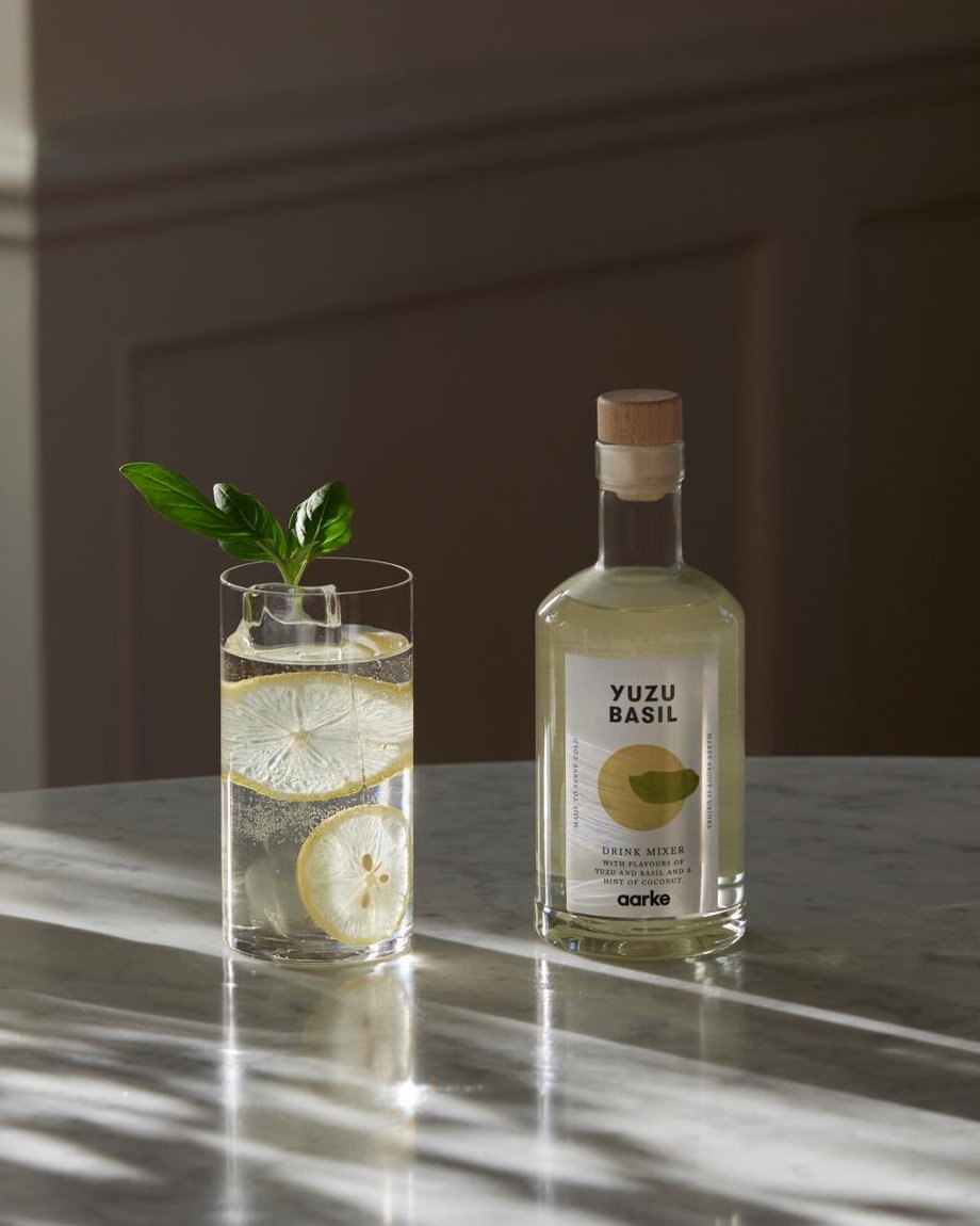 aarke drink mixer yuzu basil with a sparkling water drink on a marble table