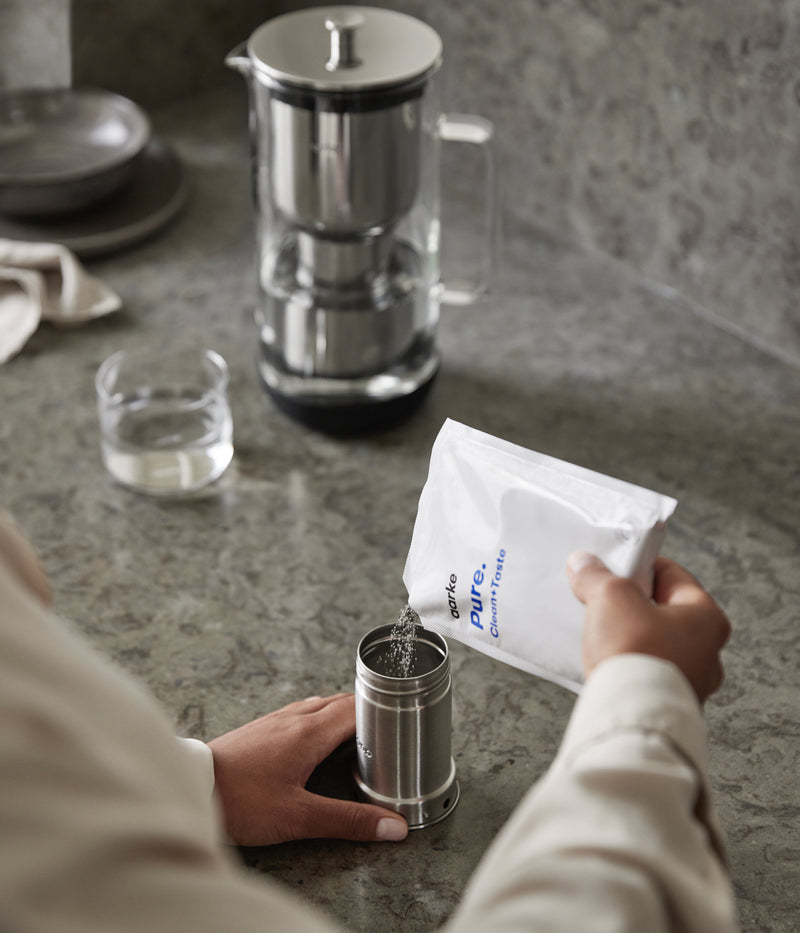 Pouring filter granules into refillable filter cartridge