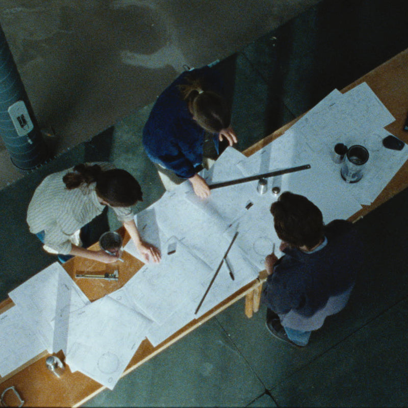 picture of the engineers at Aarke looking at drawings and desing-papers.